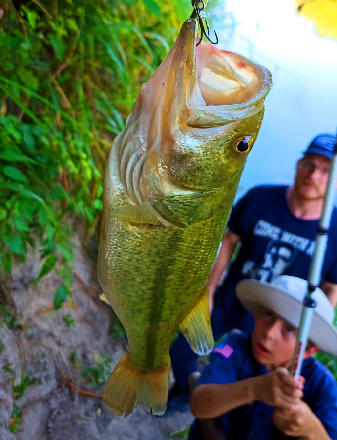 Cadet Corps Alliance youth catches a largemouth bass at River Bone Ranch